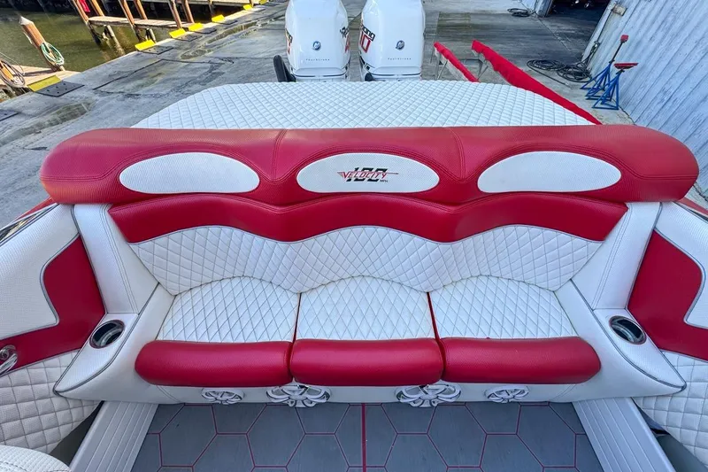 Slide: The Image of Red and white seating on 2022 Velocity 290sc boat, featuring quilted upholstery design. - 95