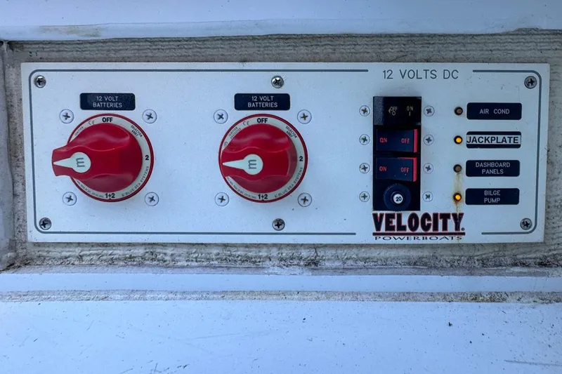 Slide: The Image of Control panel of a 2022 Velocity 290sc powerboat with battery switches and indicators. - 98