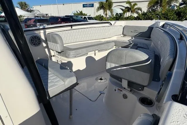 Slide: The Image of 2025 Sea Chaser 24 HFC boat interior with gray seating and modern design. - 10