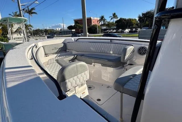 Slide: The Image of 2025 Sea Chaser 24 HFC boat interior with cushioned seating and modern design. - 4