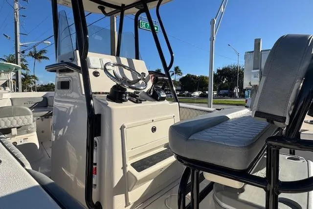 Slide: The Image of 2025 Sea Chaser 24 HFC boat interior with steering console and seating. - 6
