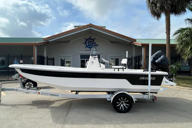 The Image of 2026 Sundance B20CCR boat on trailer outside Gulf Coast Marine building. - 0