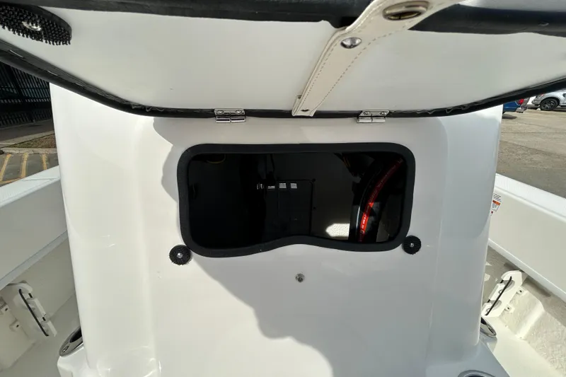 Slide: The Image of 2026 Sundance B20CCR boat storage compartment with open hatch, showcasing interior details. - 11