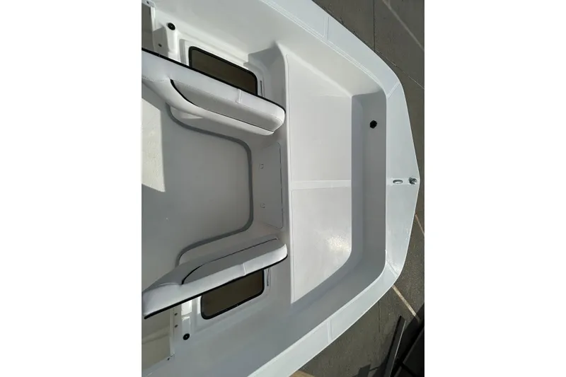 Slide: The Image of 2026 Sundance B20CCR boat interior with white seating and storage compartments. - 12