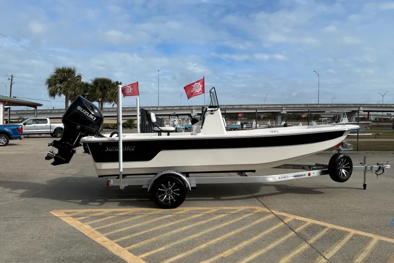 Slide: The Image of 2026 Sundance B20CCR boat on trailer with Suzuki outboard motor, parked outdoors. - 3