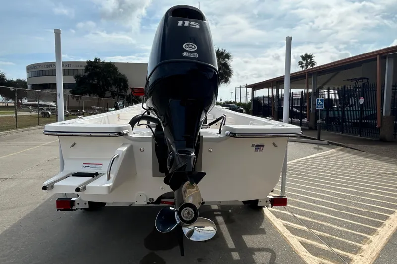 Slide: The Image of 2026 Sundance B20CCR boat with 115 horsepower engine, parked outdoors. - 7