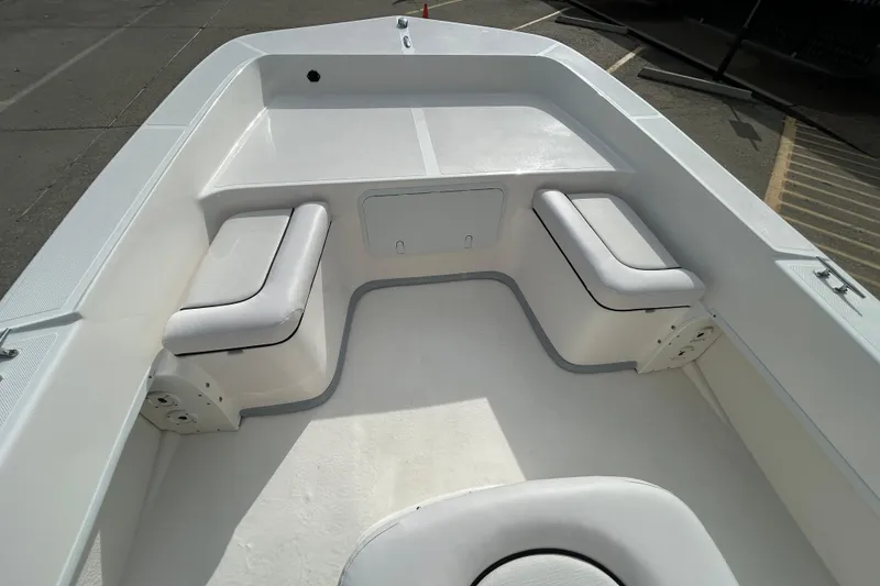 Slide: The Image of 2026 Sundance B20CCR boat interior with cushioned seating and storage compartments. - 8