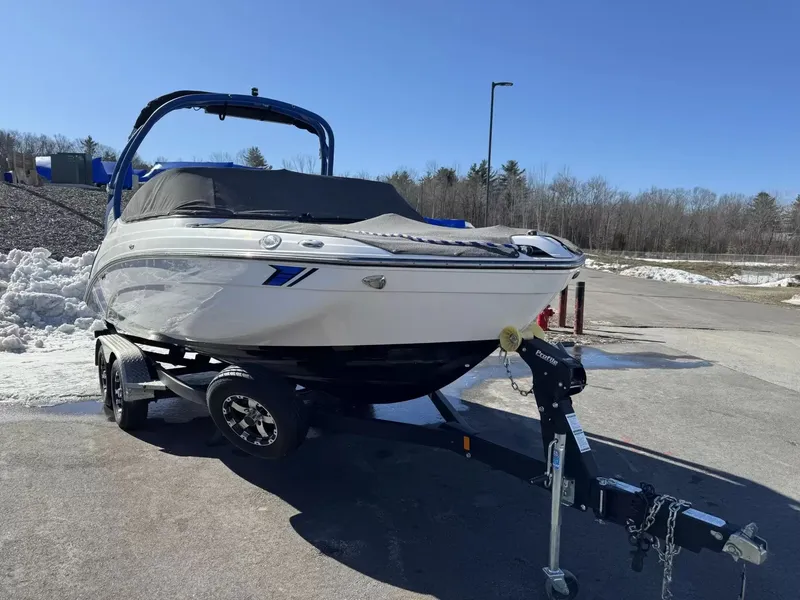 Slide: The Image of 2019 Yamaha Boats 212X on trailer parked outdoors. - 17