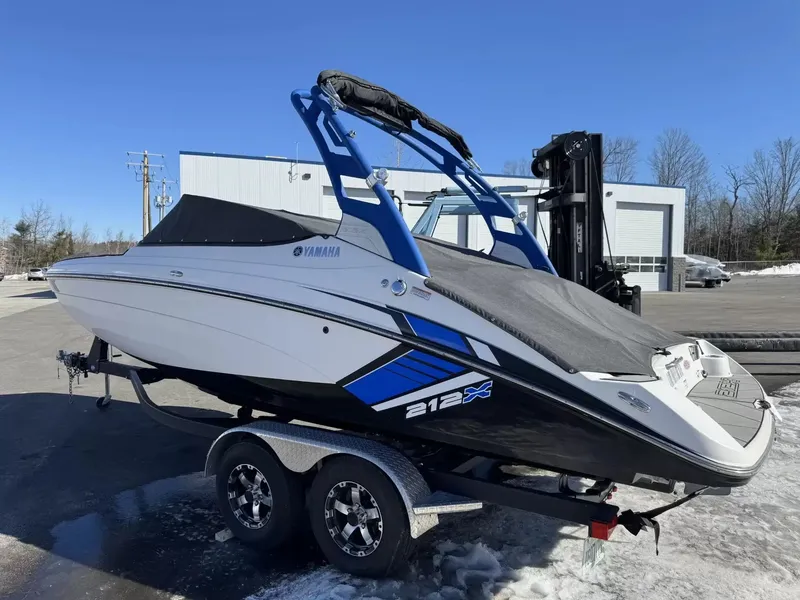 Slide: The Image of 2019 Yamaha Boats 212X on trailer, blue and white design. - 18
