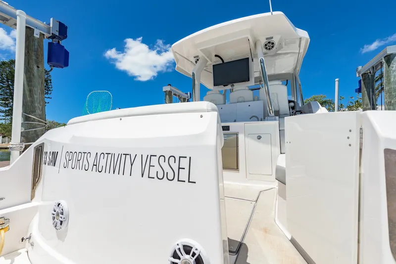 Slide: The Image of 2024 Regal 33 SAV sports activity vessel docked under clear blue sky. - 11