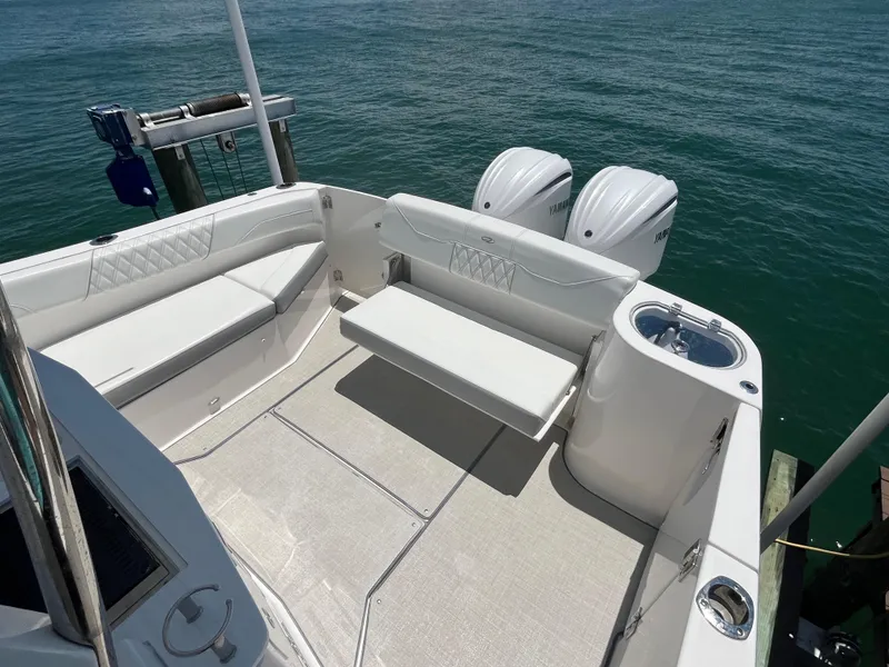 Slide: The Image of 2024 Regal 33 SAV boat deck with seating and twin Yamaha outboard engines. - 13