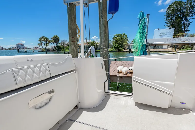 Slide: The Image of 2024 Regal 33 SAV boat interior with dock view, featuring white seating and blue sky. - 17