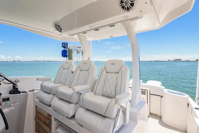 Slide: The Image of 2024 Regal 33 SAV boat interior with luxurious seating and ocean view. - 20