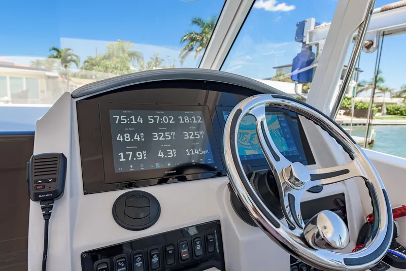 Slide: The Image of 2024 Regal 33 SAV boat dashboard with Garmin displays and steering wheel. - 22