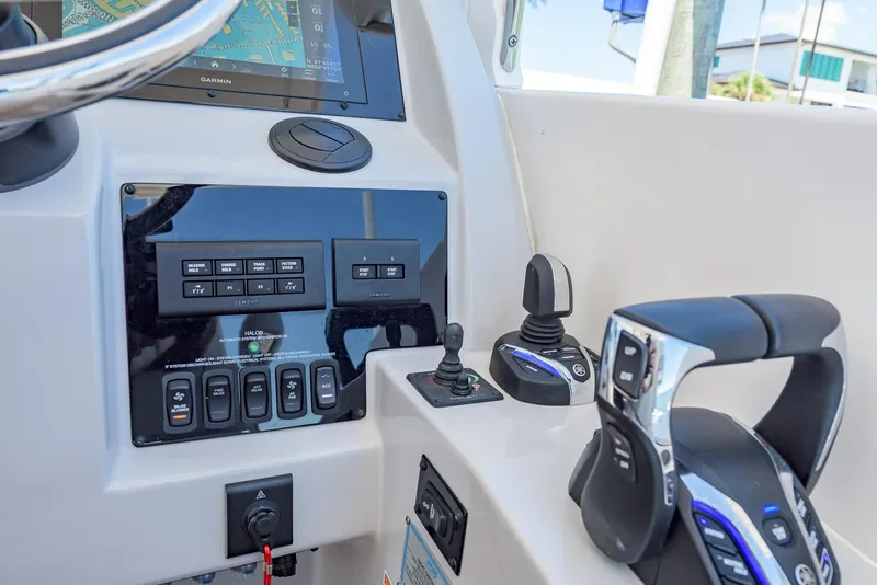 Slide: The Image of 2024 Regal 33 SAV boat dashboard with Garmin navigation and Yamaha controls. - 23