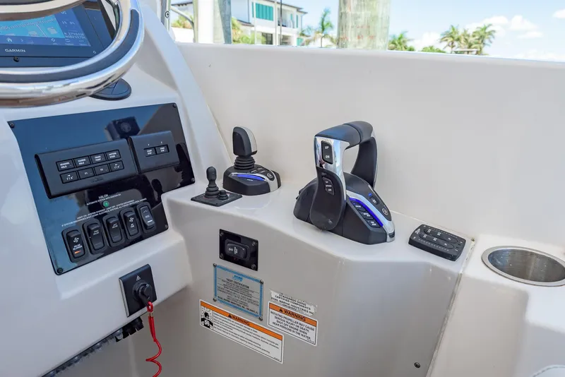 Slide: The Image of Control panel of 2024 Regal 33 SAV boat with throttle and joystick. - 24