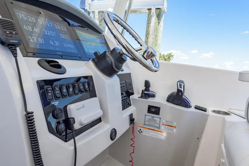 Slide: The Image of 2024 Regal 33 SAV boat dashboard with Garmin navigation and control systems. - 25