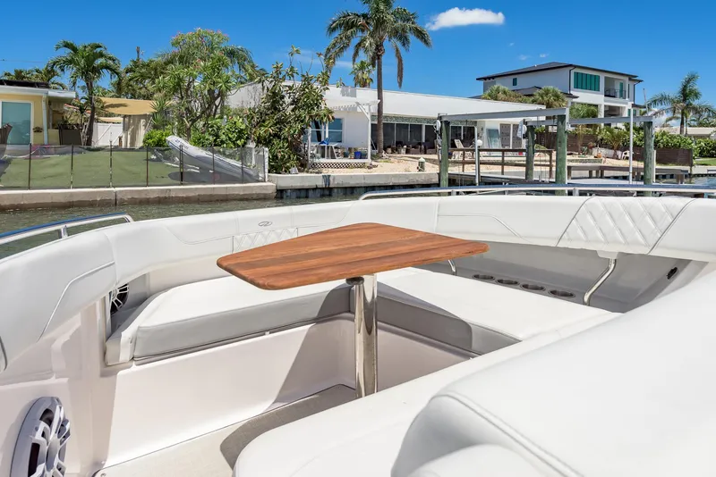 Slide: The Image of 2024 Regal 33 SAV boat deck, docked at marina with wooden pier. - 27