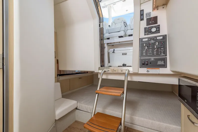 Slide: The Image of 2024 Regal 33 SAV boat anchor compartment with winch and chain. - 33