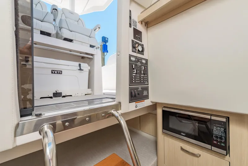 Slide: The Image of 2024 Regal 33 SAV interior cabin with ladder, control panel, and seating area. - 34