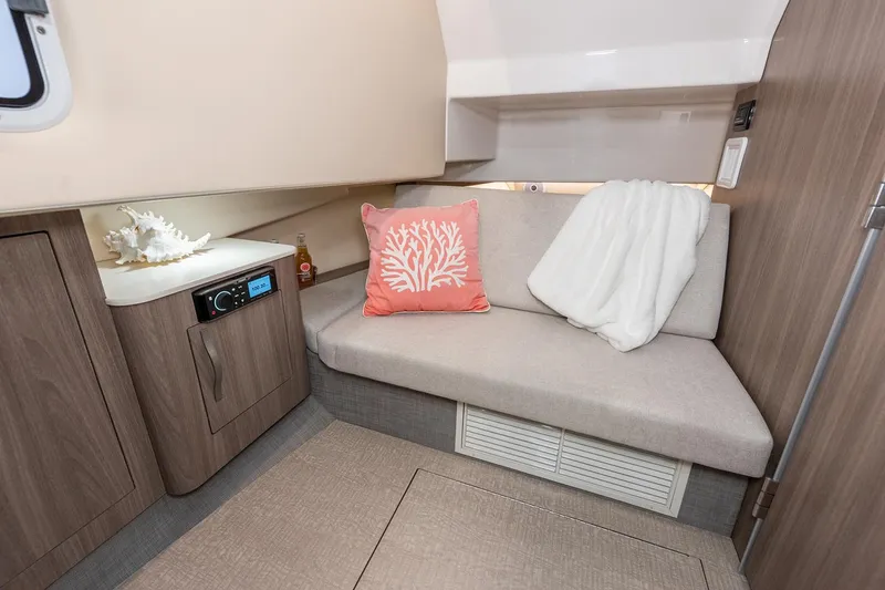 Slide: The Image of 2024 Regal 33 SAV interior with microwave, control panel, and Yeti cooler. - 35