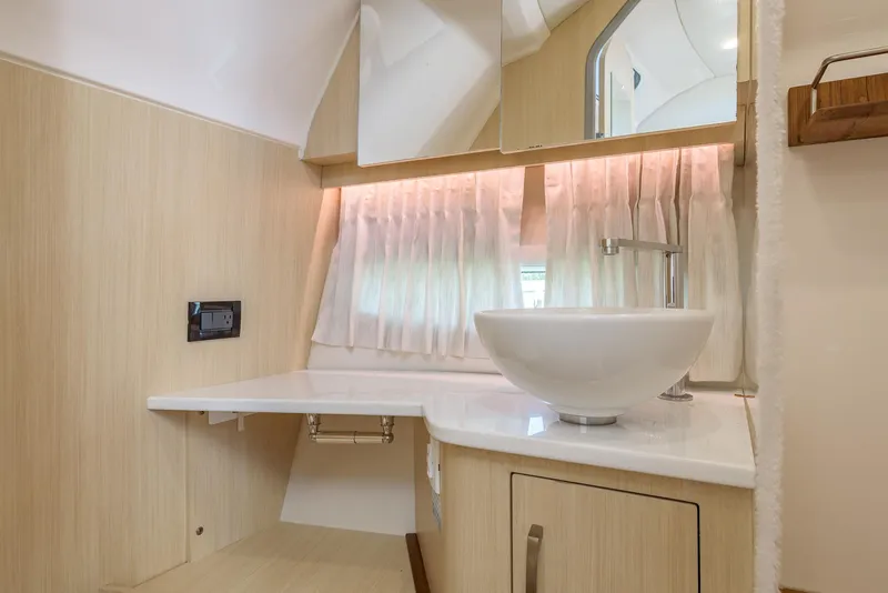 Slide: The Image of 2024 Regal 33 SAV bathroom with modern sink and elegant wood finish. - 41