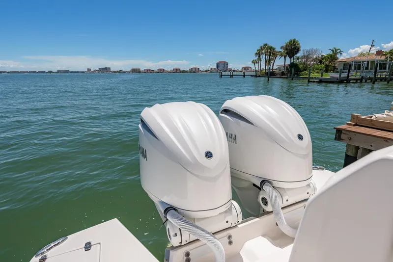 Slide: The Image of 2024 Regal 33 SAV boat with twin Yamaha outboard engines on a sunny waterfront. - 9