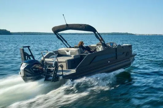 Slide: The Image of Manufacturer Provided Image: 2026 Evotti 521CS boat cruising on open water under clear blue skies. - 2
