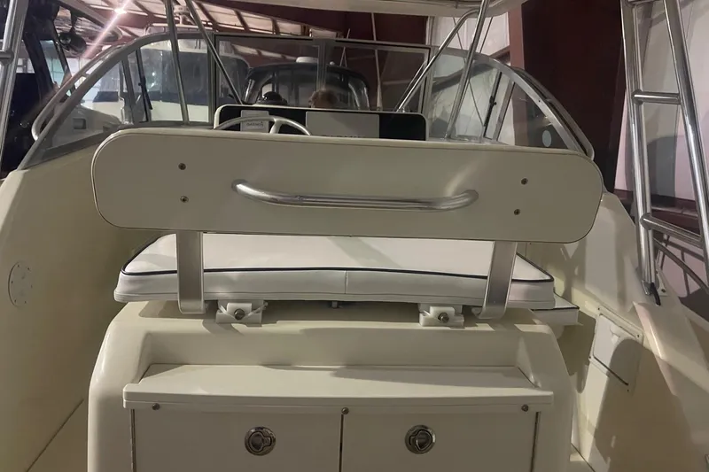 Slide: The Image of 2000 Pursuit 3070 Offshore Center Console interior with seating and storage. - 12