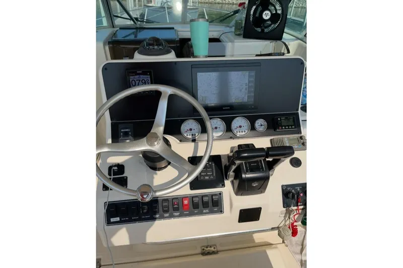Slide: The Image of Center console of 2000 Pursuit 3070 Offshore boat with steering wheel and controls. - 13