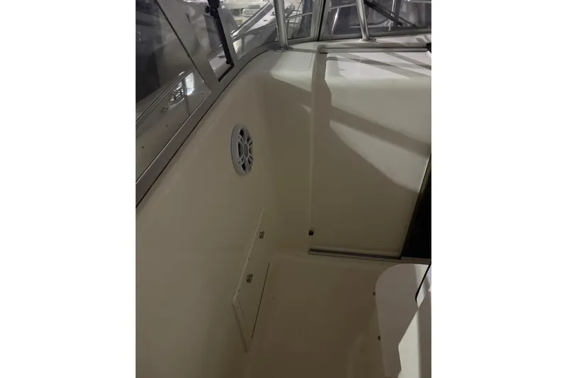 Slide: The Image of 2000 Pursuit 3070 Offshore Center Console interior with speaker and storage compartment. - 14