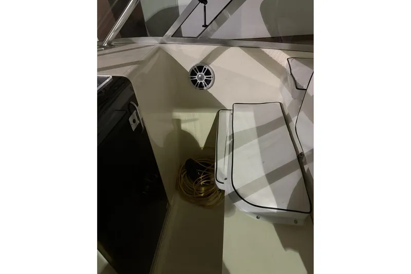 Slide: The Image of Interior of 2000 Pursuit 3070 Offshore Center Console boat with seating and speaker. - 15