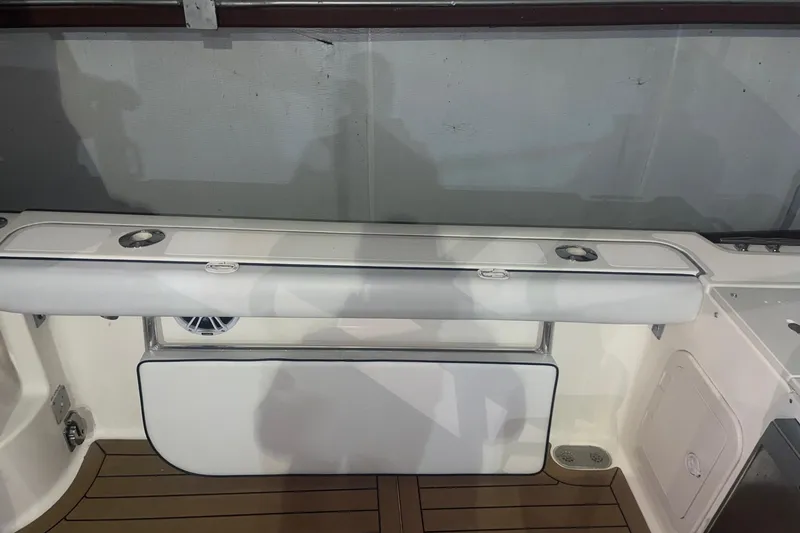 Slide: The Image of 2000 Pursuit 3070 Offshore Center Console boat interior with seating and storage. - 16