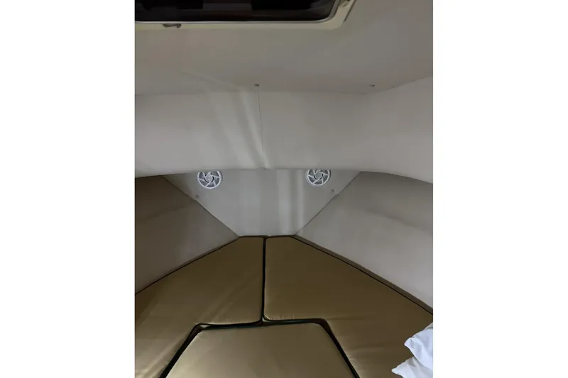 Slide: The Image of Interior cabin of 2000 Pursuit 3070 Offshore Center Console boat with cushioned seating. - 18