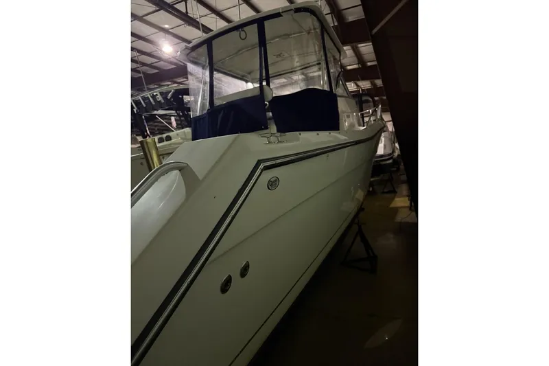 Slide: The Image of 2000 Pursuit 3070 Offshore Center Console boat in indoor storage. - 2