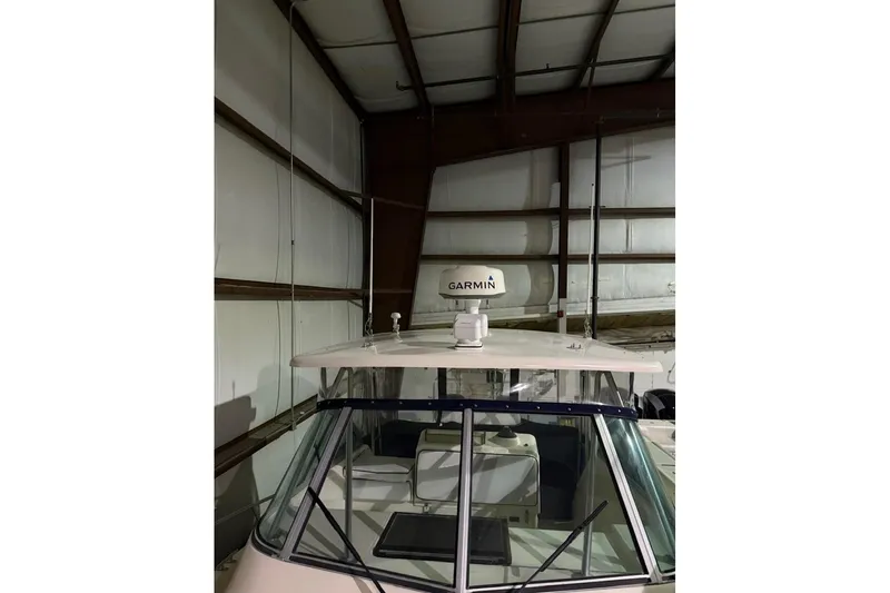 Slide: The Image of 2000 Pursuit 3070 Offshore Center Console boat with Garmin radar in storage. - 3