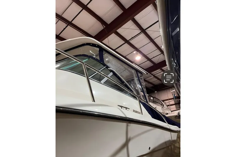 Slide: The Image of 2000 Pursuit 3070 Offshore Center Console boat in indoor storage facility. - 5
