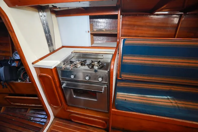 Slide: The Image of Interior of 1983 Nelson Marek 36 sailboat with stove and striped seating. - 12