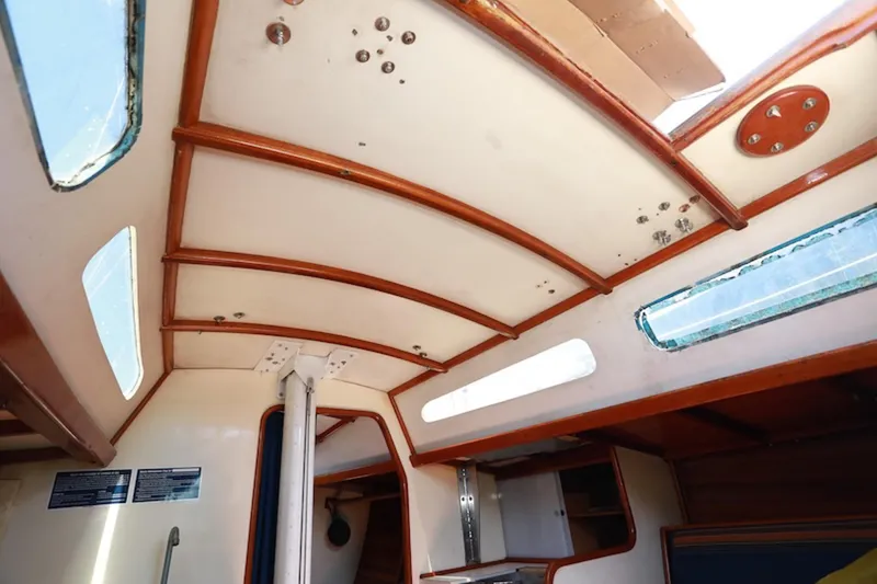 Slide: The Image of Interior view of 1983 Nelson Marek 36 sailboat, featuring wooden beams and windows. - 17
