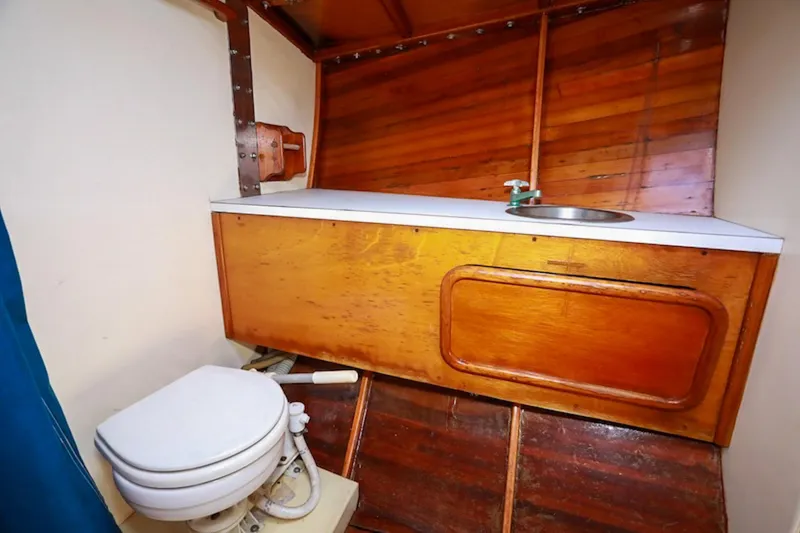 Slide: The Image of 1983 Nelson Marek 36 yacht bathroom with wooden cabinetry and compact toilet. - 18