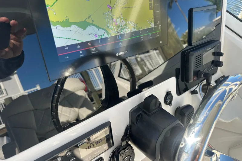 Slide: The Image of 2023 Edgewater 248CX Crossover boat dashboard with Garmin navigation display. - 14