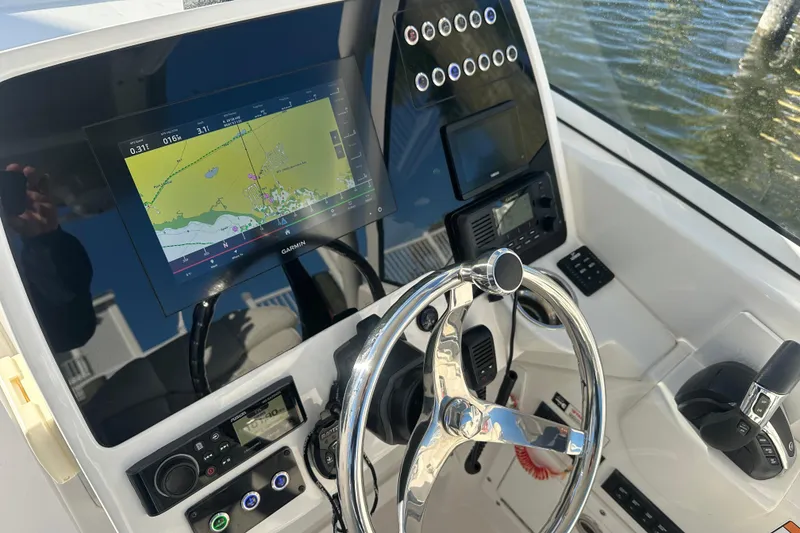 Slide: The Image of 2023 Edgewater 248CX Crossover boat dashboard with navigation system and controls. - 15