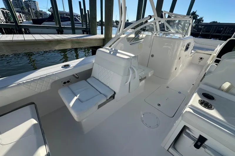Slide: The Image of 2023 Edgewater 248CX Crossover boat interior with white seating and sleek design. - 8