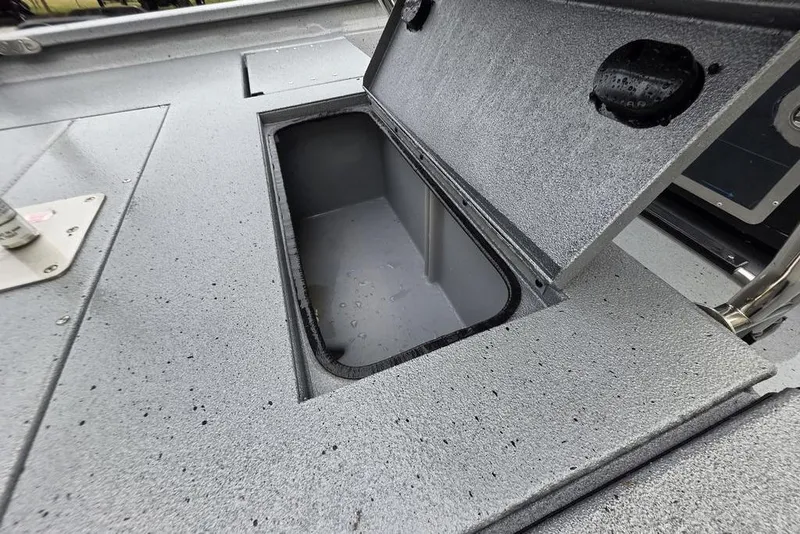 Slide: The Image of Open storage compartment on 2025 Xpress H22B Bay boat deck. - 11