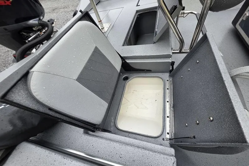 Slide: The Image of 2025 Xpress H22B Bay boat seat with storage compartment, wet from rain. - 13