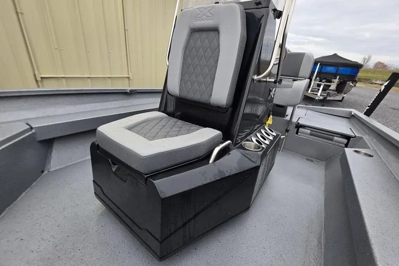 Slide: The Image of 2025 Xpress H22B Bay boat interior with cushioned seating and cup holders. - 25