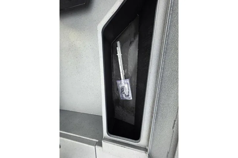 Slide: The Image of Compartment in 2025 Xpress H22B Bay boat with a small plastic bag inside. - 28