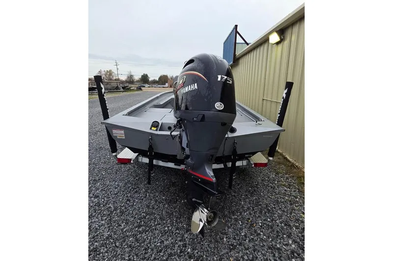 Slide: The Image of 2025 Xpress H22B Bay boat with Yamaha 175 engine, parked on gravel. - 4
