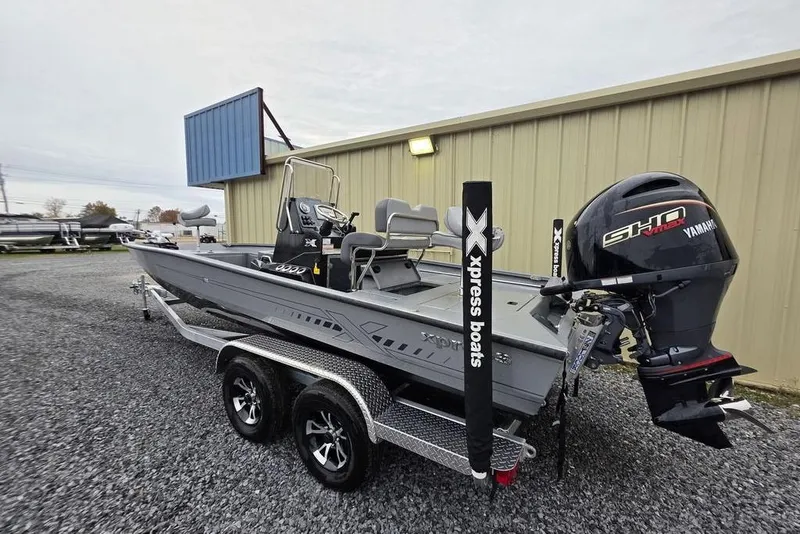 Slide: The Image of 2025 Xpress H22B Bay boat with Yamaha engine on a trailer, parked outdoors. - 5