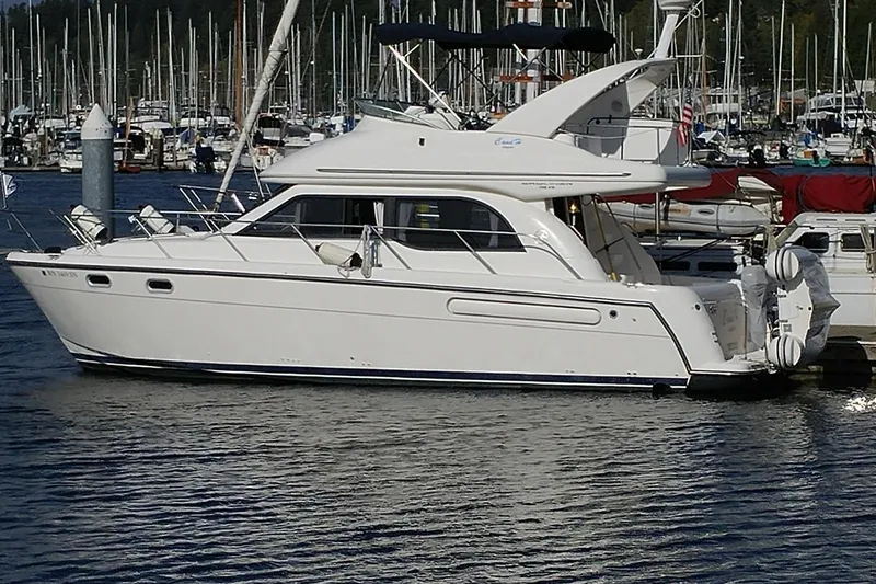 The Image of 2001 Bayliner 3488 Command Bridge Motoryacht docked in a marina. - 0